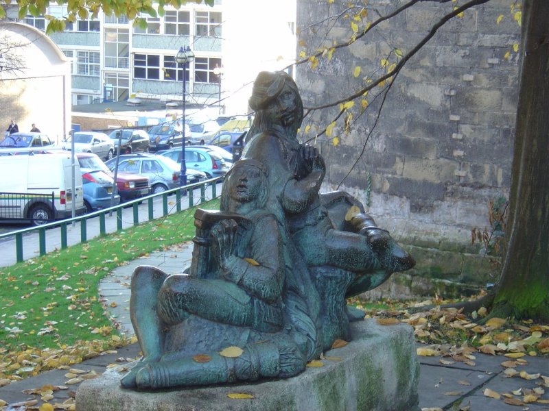 Alan-a-Dale plays the harp to Will Scarlet, left side view